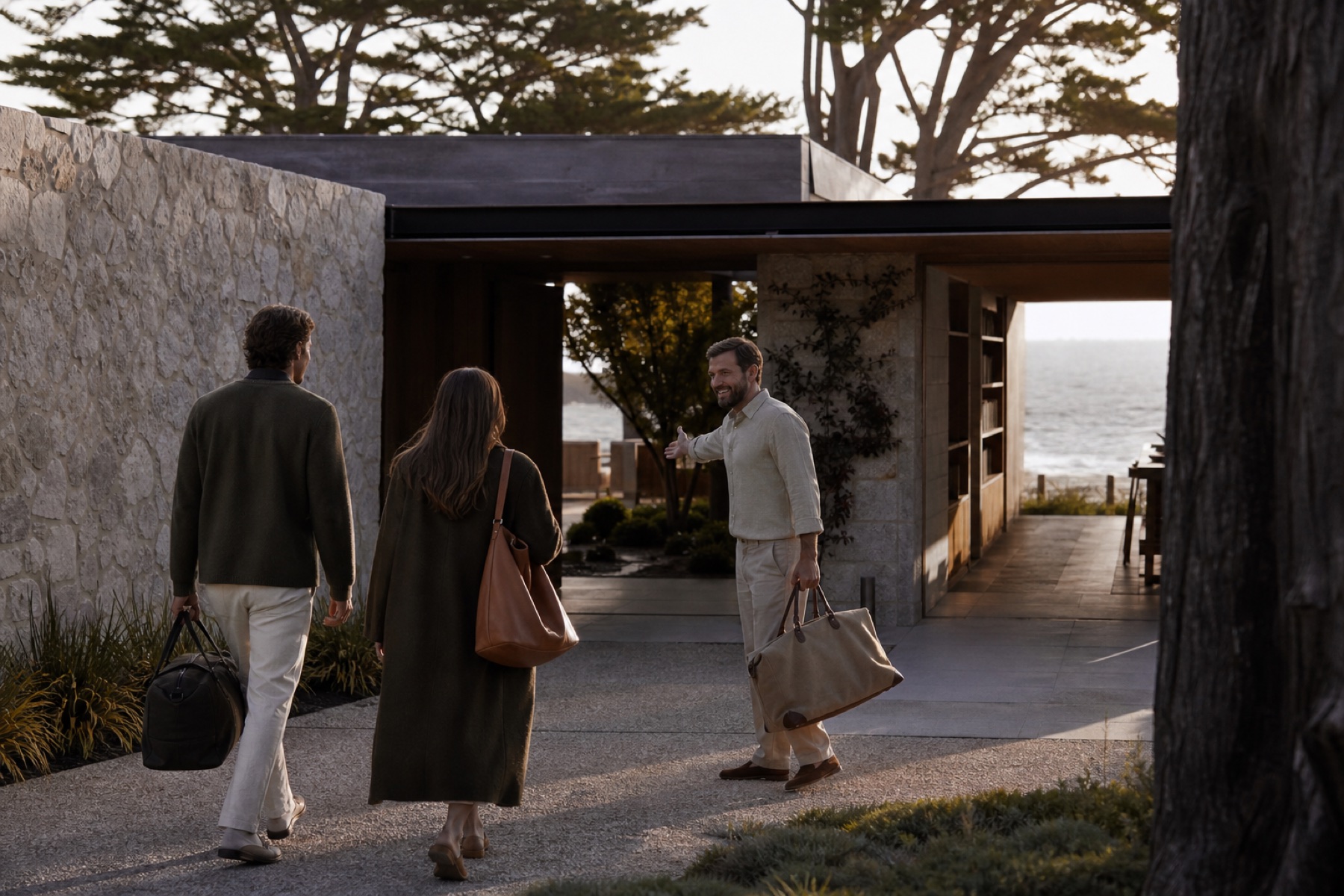 Host welcoming two travelers at a low modern coastal resort arrival court